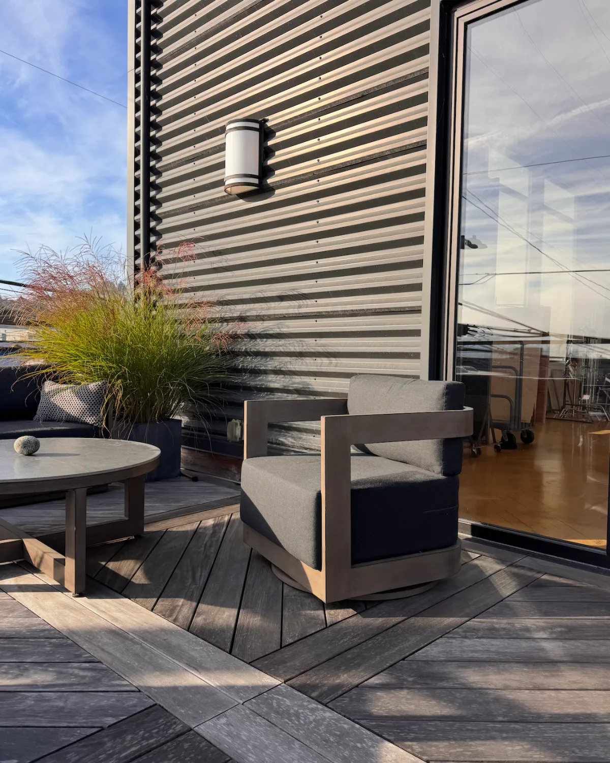 Outdoor deck at the Light Loft event space in Seattle — lounge seating and planters beside a wall of folding glass doors
